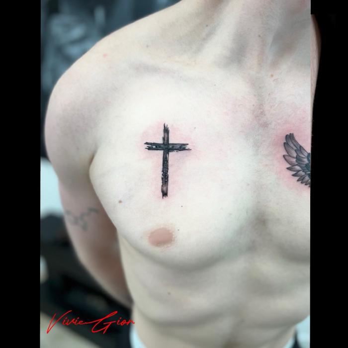  realistic tattoo of cross on the chest of a man