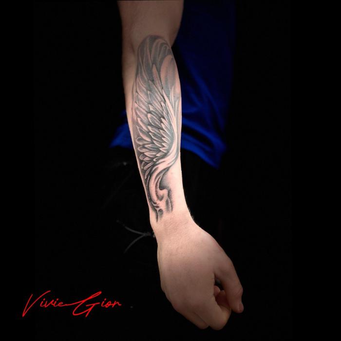  realistic tattoo in realism of angelic looking armor on hand 