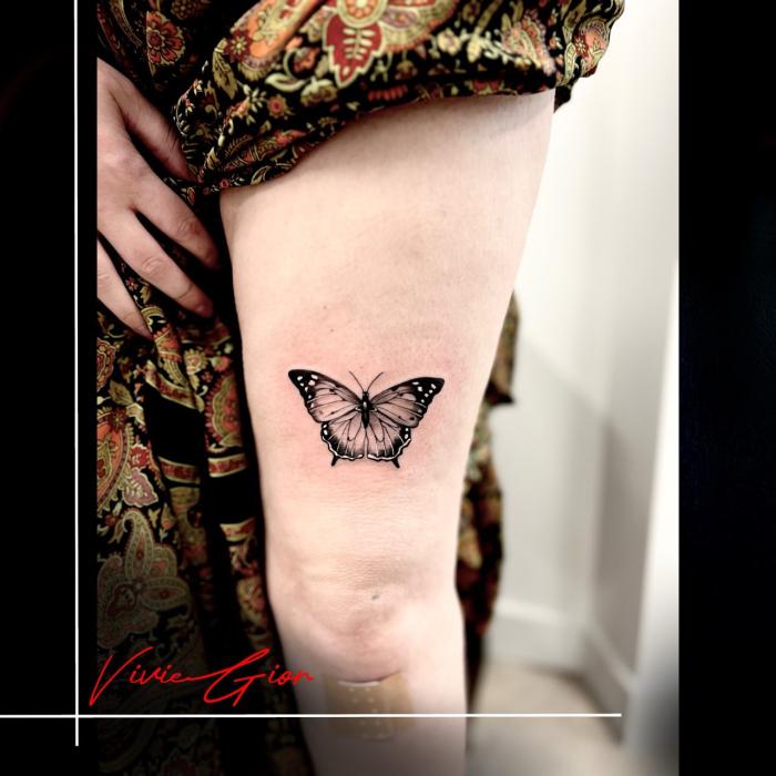  realistic tattoo of butterfly on hand of a woman