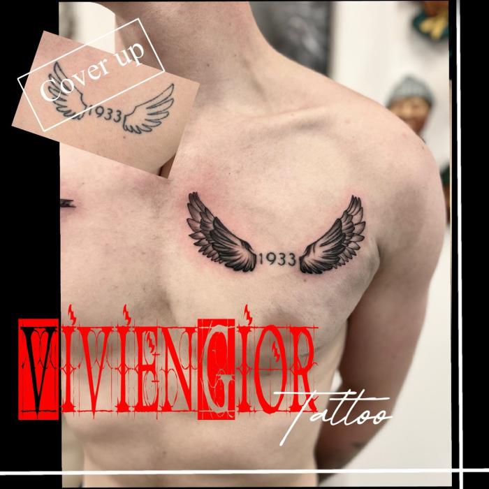 realistic tattoo of 1933 between wings on chest