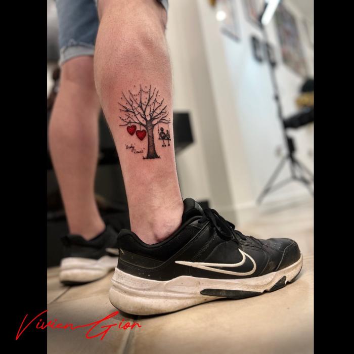  realistic tattoo of a tree tattooed on the mans calf