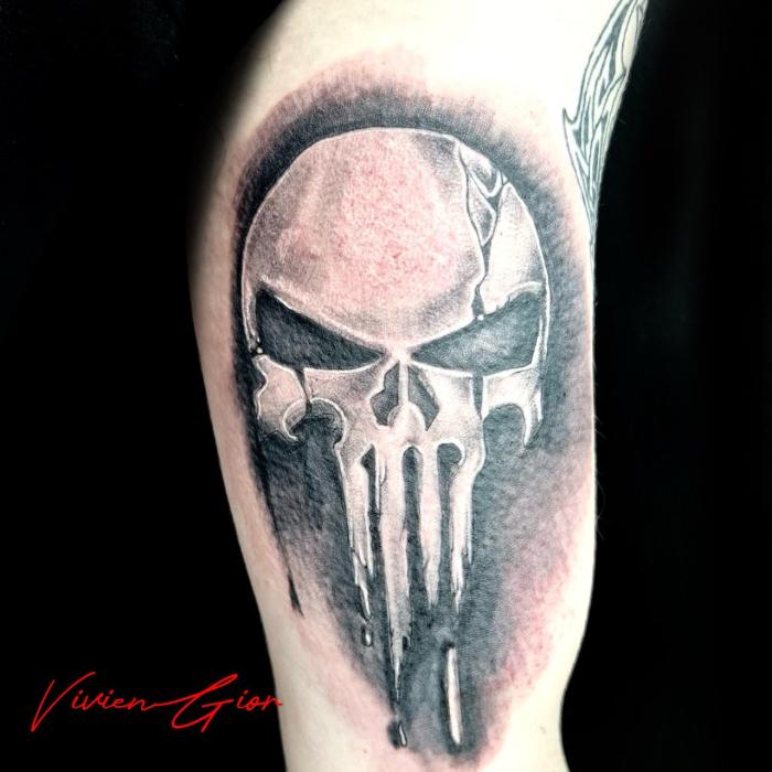 realistic tattoo of skull tattooed on hand looking menancing