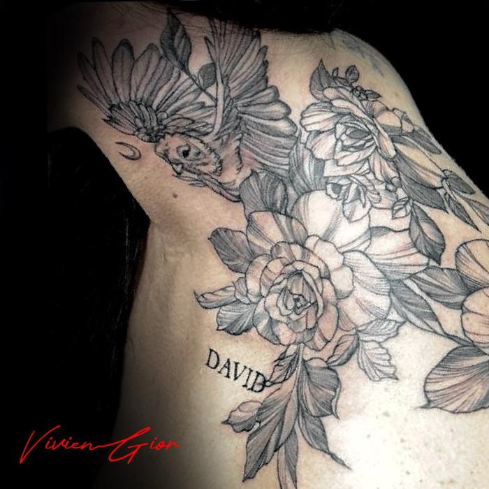 realistic tattoo of black and white flowers on neck 