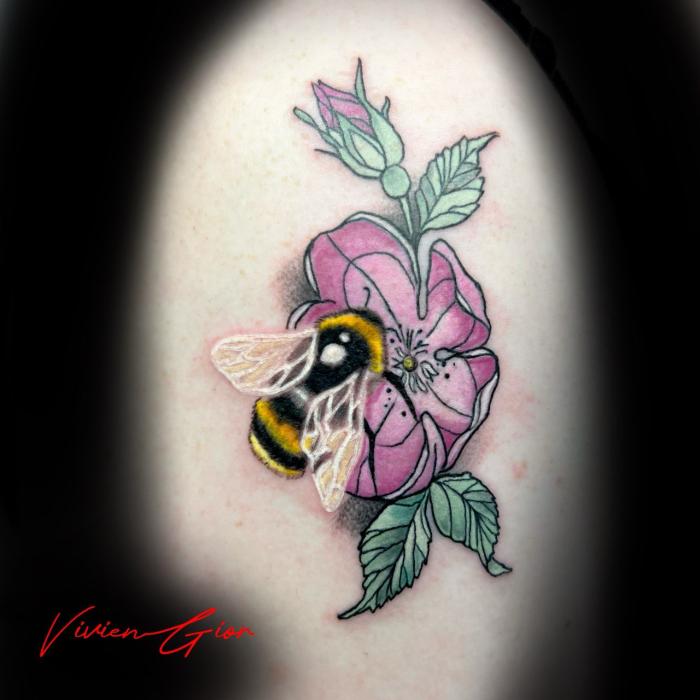 realistic tattoo of bumblebee sitting at the flower tattooed on the leg