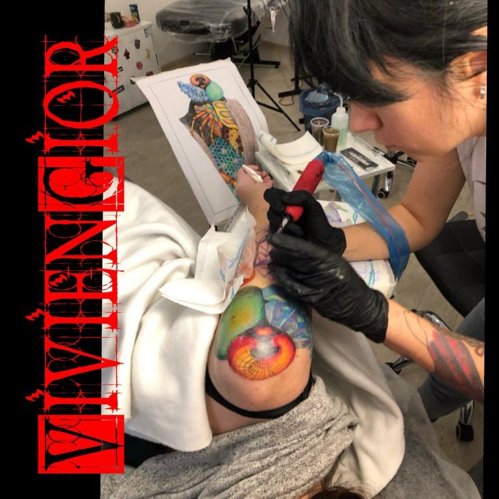  geometric realistic tattoo on hand with woman tattooing it