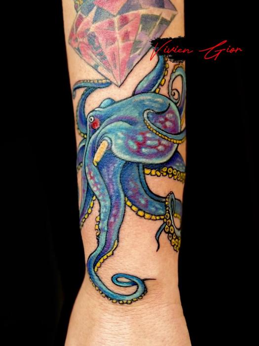  realistic tattoo of colorful octopus tattooed on hand 