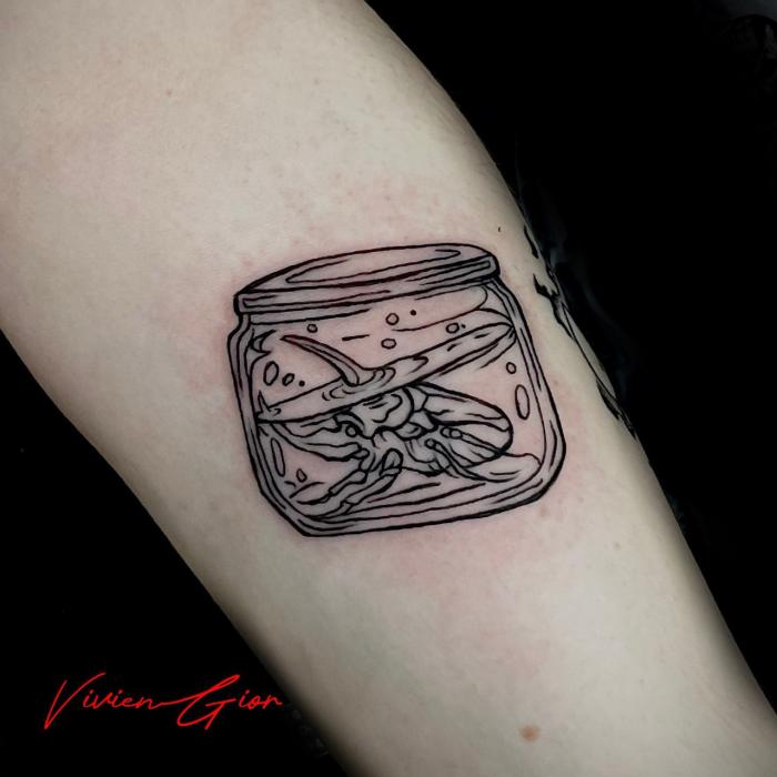  tattoo of a cartoon looking bug stuck in the jar trying to escape while jar fills up with water and having a lid